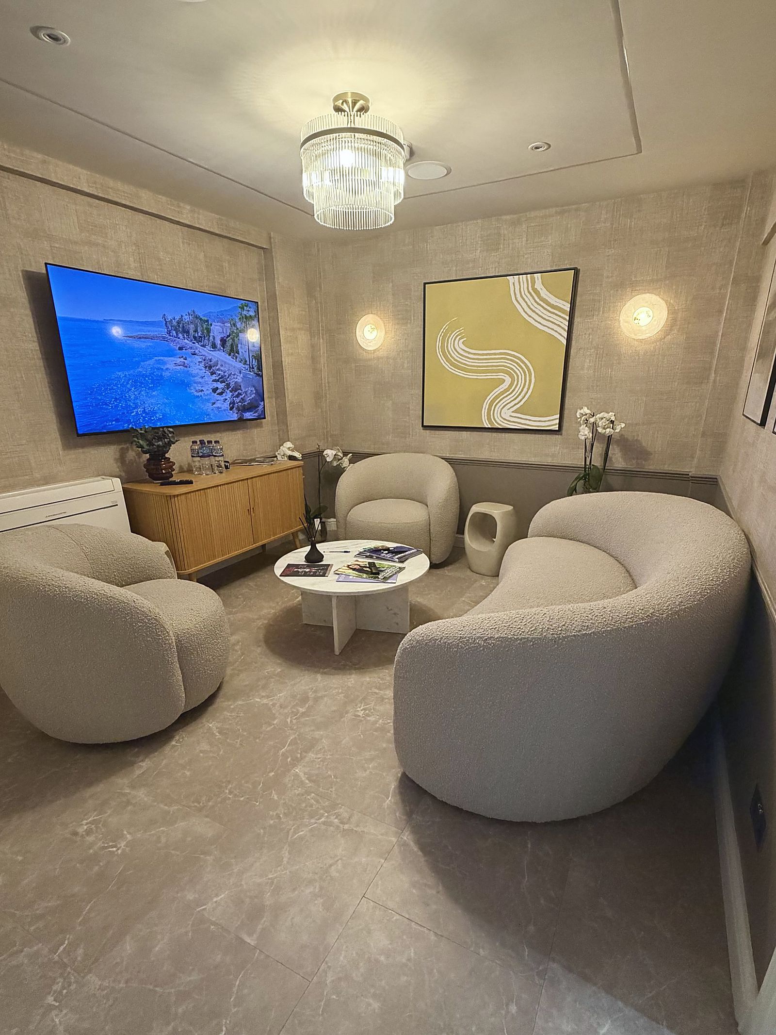 The waiting lounge at DROM Clinic, with curved boucle seating