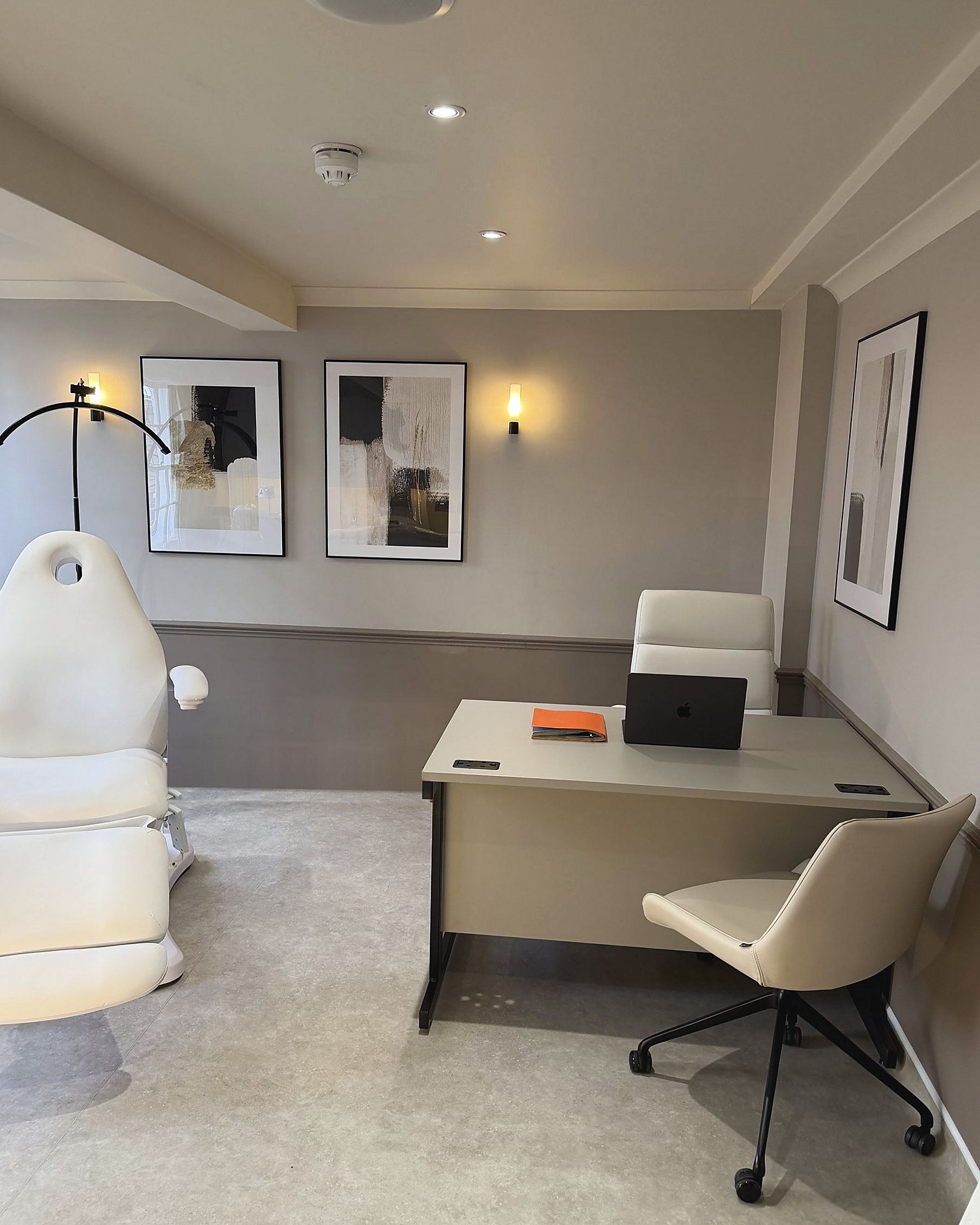A consultation room at DROM Clinic, with a desk and treatment chair
